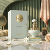 A luxurious lifestyle shot of the Juman Exclusive 100ml bottle and gift box, styled on a marble surface with pearls, rose petals, and decorative accents.