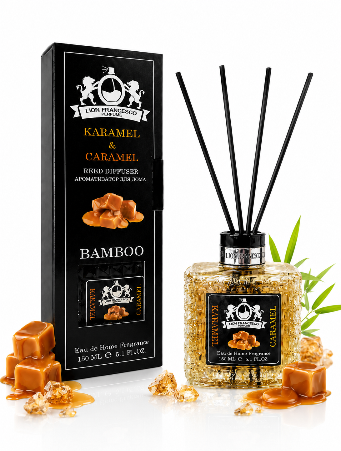 A reed diffuser bottle with black reeds and a black label next to its black retail box, both branded Lion Frankoo Parfum. The scent is Karamel & Caramel Bamboo, with caramel pieces and syrup used as styling props on a white background.