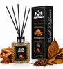 Lion Francesco Sandal & Tobacco Reed Diffuser 150 ml with black reeds, displayed beside its black packaging with sandalwood pieces and dried tobacco leaves on a white background.