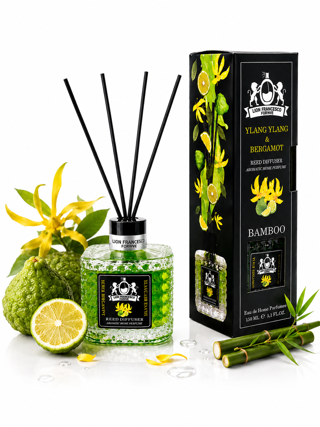 A reed diffuser bottle with green liquid and reeds, shown beside its black branded box. The scene is styled with yellow bergamot flowers, a bergamot fruit, a sliced lime, and bamboo stalks on a clean white background.