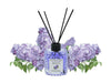 Lion Francesco Lilac Flower reed diffuser 150 ml bottle with rattan sticks surrounded by lilac blossom